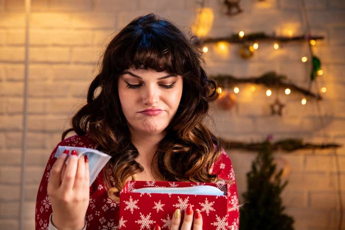 person who looks upset after opening a present