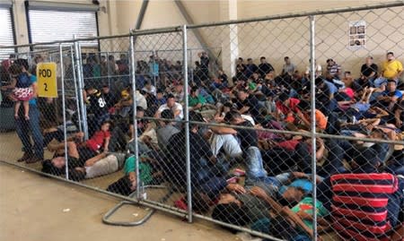 An overcrowded fenced area holding families at a Border Patrol station is seen in McAllen