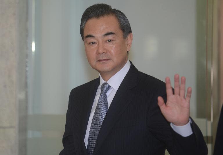 Chinese Foreign Affairs Minister Wang Yi waves to media in New Delhi on June 8, 2014