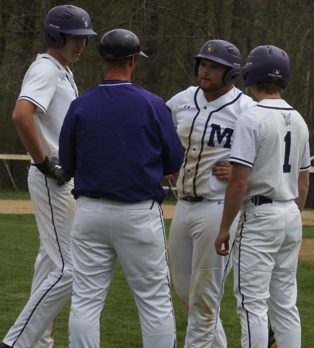Ronan Casey, Riley Parnham and Silas Reimels surrounding head coach Eric Wells during Marshwood's 12-5 win over Noble on Saturday at Marshwood High School