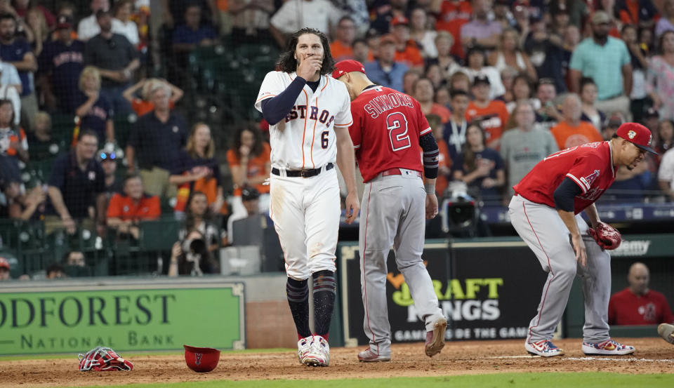 Houston Astros' Jake Marisnick (6) reacts after colliding with Los Angeles Angels catcher Jonathan Lucroy during the eighth inning of a baseball game Sunday, July 7, 2019, in Houston. (AP Photo/David J. Phillip)