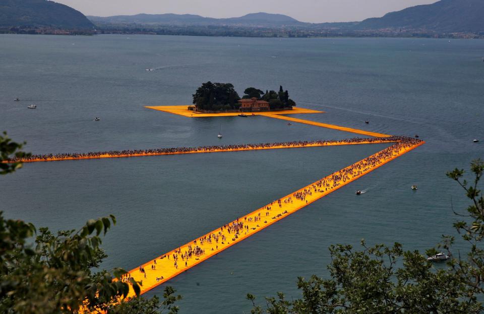 People walking on Christo's 'Floating Piers' on Lake Iseo, Italy in 2016 - Wolfgang Rattay/ REUTERS