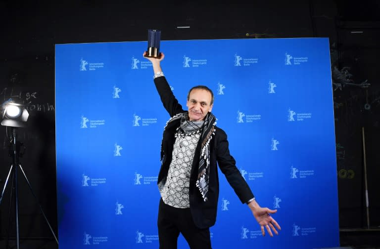 Palestinian director Raed Andoni poses after being awarded for Best documentary for his film "Istiyad Ashbah" (Ghost Hunting) after the Award Ceremony of the 67th Berlinale film festival in Berlin on February 18, 2017