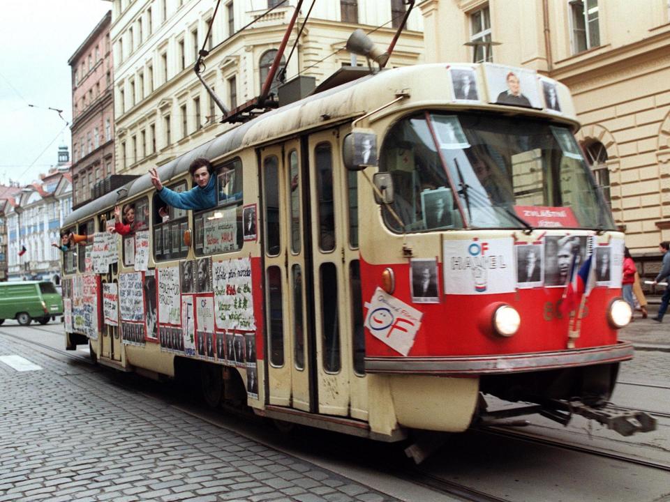 Young Czechoslovak people wave from a tramway in support of Vaclav Havel for presidency during a protest rally on 17 December 1989 near Wenceslas Square in Prague: Lubomir Kotek/AFP/Getty