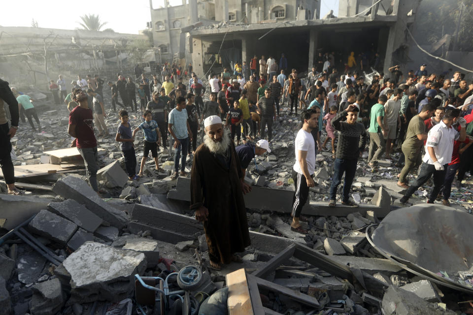 Palestinians look for survivors following an Israeli airstrike in Khan Younis refugee camp, southern Gaza Strip, Tuesday, Nov. 7, 2023. (AP Photo/Mohammed Dahman)