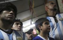 An Argentina fan (2nd R) cries as he watches the World Cup final match between Argentina and Germany, near Maracana stadium in Rio de Janeiro July 13, 2014. REUTERS/Nacho Doce (BRAZIL - Tags: SPORT SOCCER WORLD CUP)