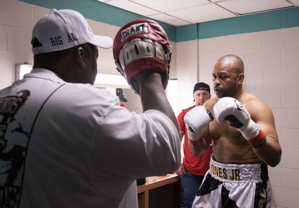 Trainer Alfy Smith, left, helps prepare Roy Jones Jr. for his final fight of his career at the Island Fights at the Pensacola Bay Center on Thursday, February 8, 2018.