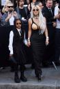 <p>In a coordinated style moment with her mom, West embraced steampunk style in a gray pinstripe skirt suit, which featured four separate pieces: a pleated skirt, vest, tie, and beret. She added a nose ring for an attention-grabbing accessory.</p>