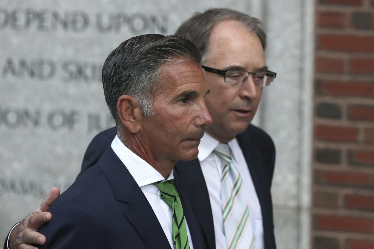 Mossimo Giannulli, left, departs federal court in Boston on April 3, 2019.