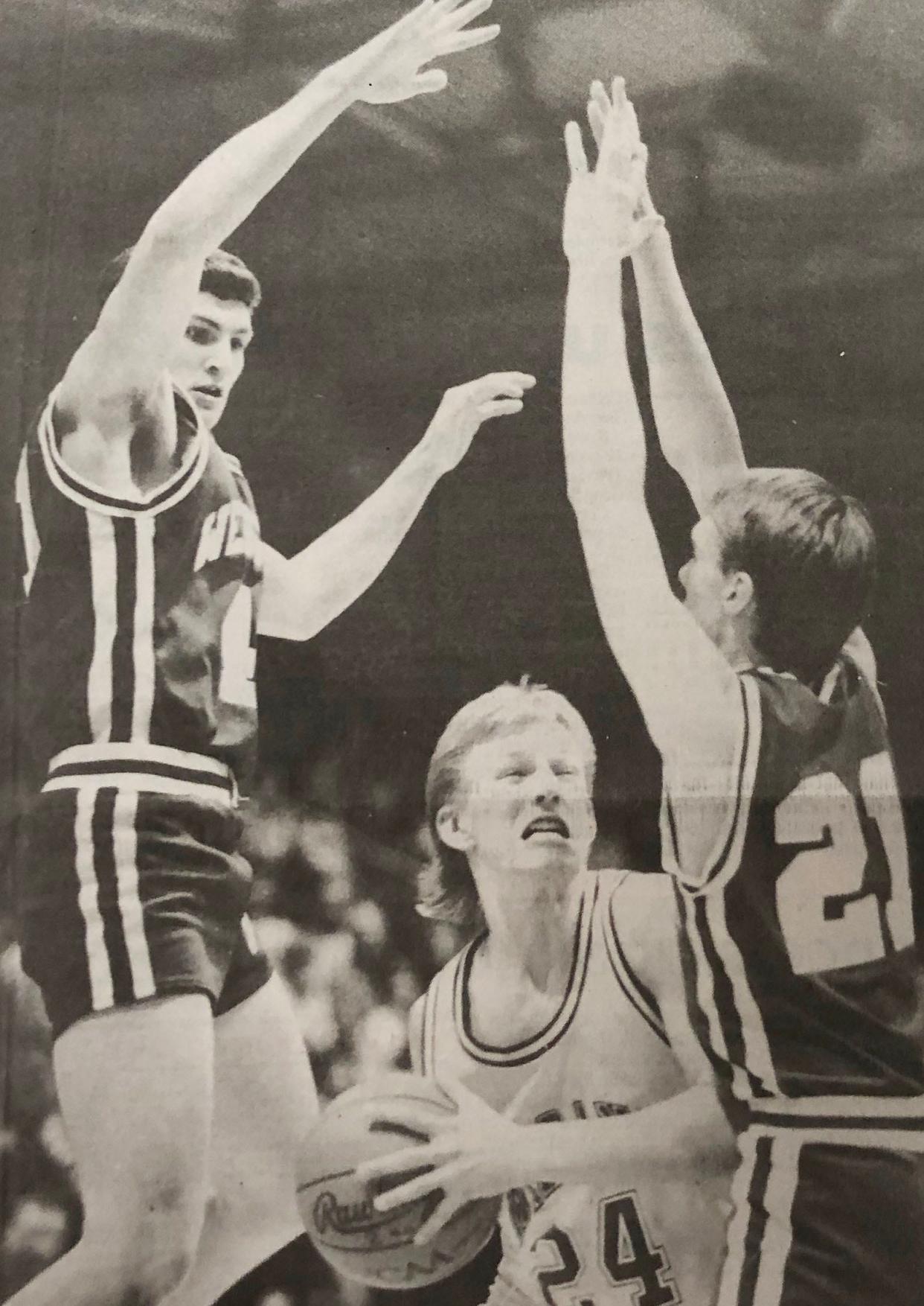 Yes Milbank's Kalen DeBoer was included in the list of "20 Favorites' area high school football player when the story ran this summer. We couldn't find a football photo of DeBoer, the head coach of the unbeaten University of Washington football team, but here's a basketball shot of him trying to score against Webster's Steve Wagner (left) and Darren Gollnick during their District 1A game in 1992.