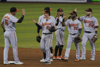 Baltimore Orioles players celebrate their win over the Miami Marlins, Tuesday, April 20, 2021, in Miami. (AP Photo/Marta Lavandier)