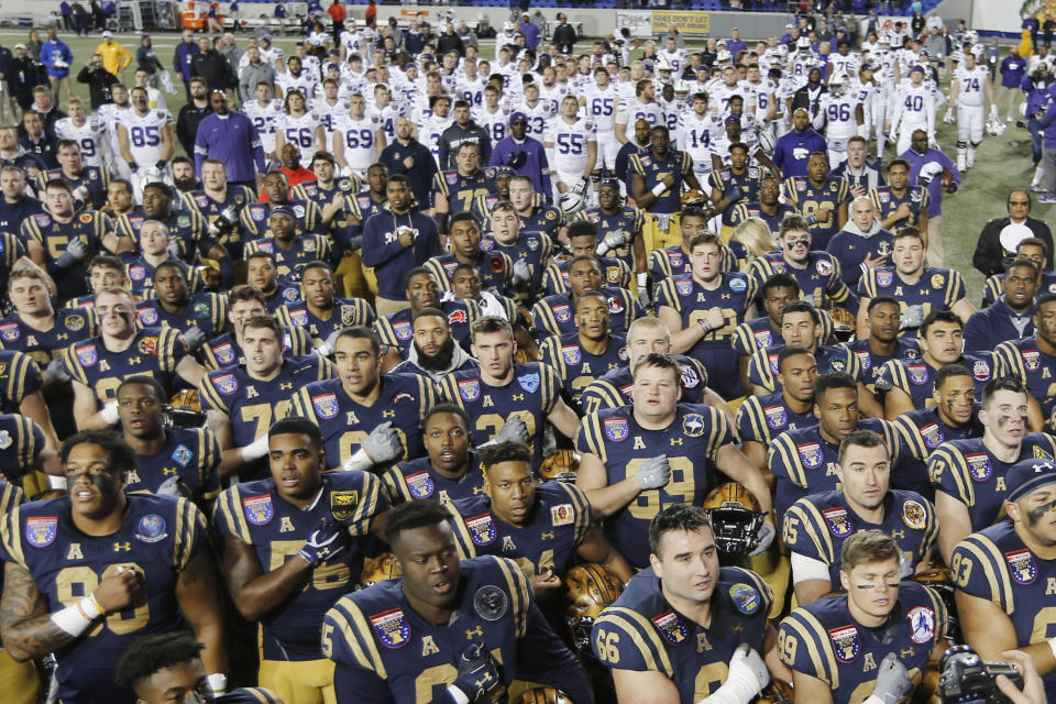 Navy players sing their alma mater as Kansas State players, top, stand and listen before leaving the field after the Liberty Bowl NCAA college football game Tuesday, Dec. 31, 2019, in Memphis, Tenn. Navy won 20-17. (AP Photo/Mark Humphrey)