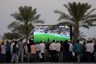 People watch the soccer match between Qatar and Senegal at a public viewing area in Al-Ruwais, Qatar, Friday, Nov. 25, 2022. (AP Photo/Matthias Schrader)