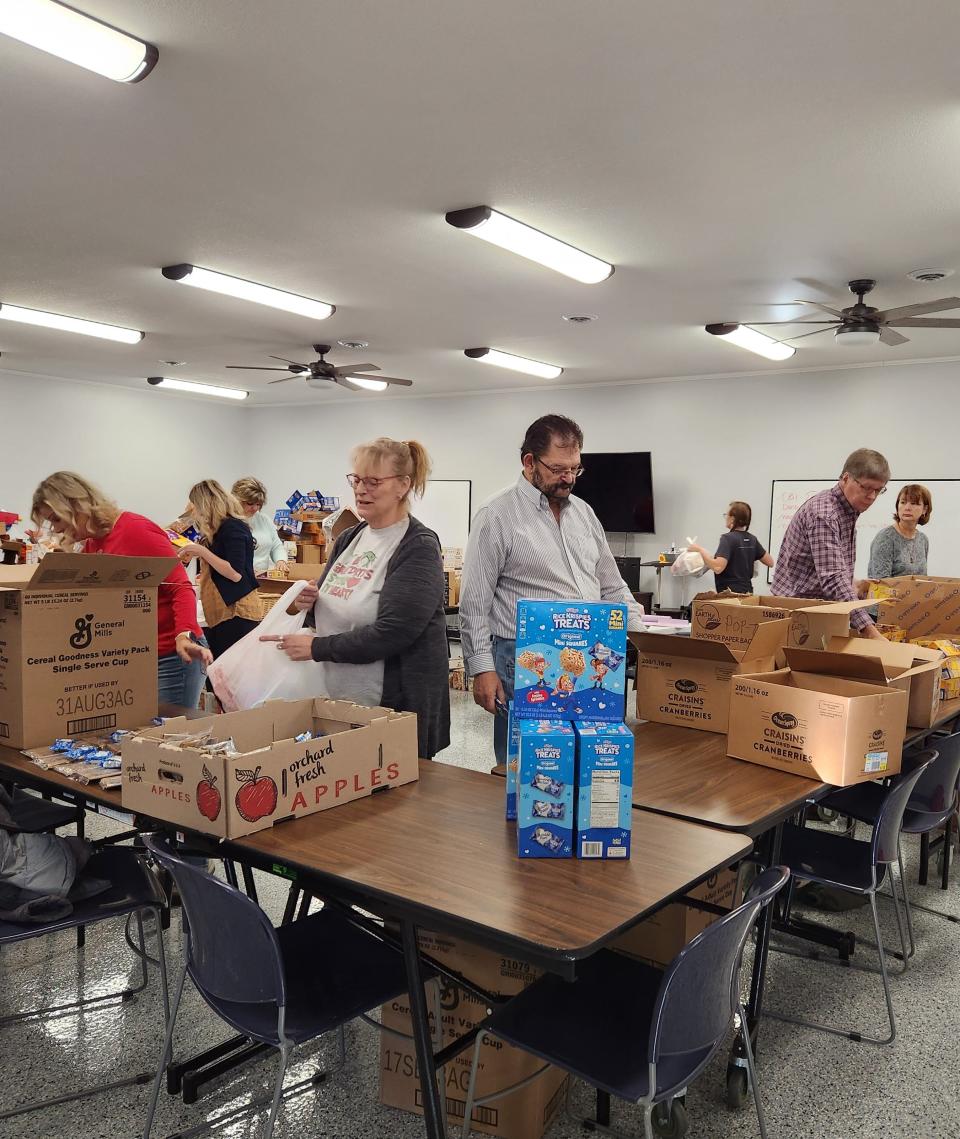 Staff and volunteers pack 500 food bags to be distributed to Ottawa County Schools.