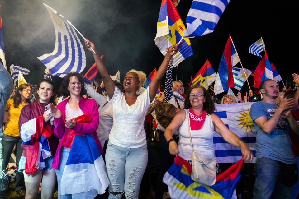 Supporters of Uruguay's presidential candidate for the Broad Front ruling party, Daniel Martinez, cheer as he speaks during a cultural event in Montevideo, Uruguay,Tuesday, Nov. 19, 2019. Uruguay will hold run-off presidential elections on Nov. 24 between Daniel Martinez and the presidencial candidate for the National Party, Luis Lacalle Pou . (AP Photo/Matilde Campodonico)