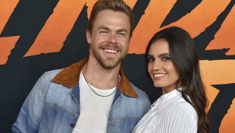 Derek Hough, left, and Hayley Erbert arrive at the premiere of “Indiana Jones and the Dial of Destiny,” on June 14, 2023. Hough shared on Thursday that his wife, Erbert, was rushed to the hospital for an “emergency craniectomy.”