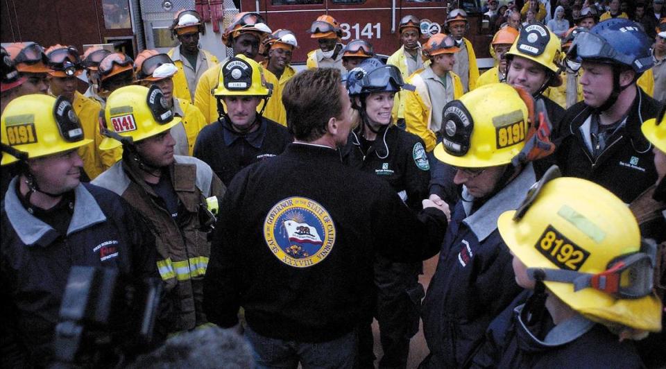 California Gov. Arnold Schwarzenegger thanks firefighters in downtown Paso Robles for their work after the San Simeon Earthquake. He is shaking hands with a Paso Robles firefighter.