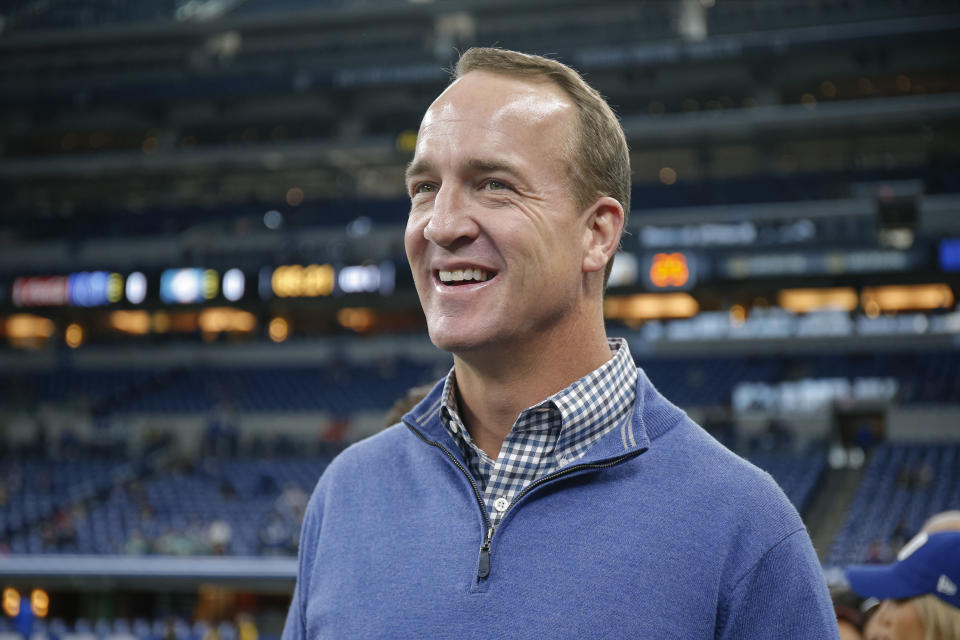 Payton Manning stands on the sideline as a non-player.