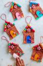 <p>You can hang these on a door, on the tree or wherever else you need a dose of good cheer. Bonus: Made from craft sticks, beads and other common art supplies, they're less of a crummy mess than a real gingerbread house.</p><p><a href="https://studiodiy.com/diy-popsicle-stick-gingerbread-house-ornaments/" rel="nofollow noopener" target="_blank" data-ylk="slk:Get the tutorial at Studio DIY »" class="link rapid-noclick-resp"><em>Get the tutorial at Studio DIY »</em></a></p>