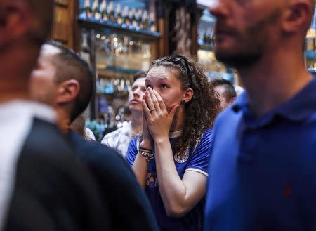 Leicester City fans react during their team's soccer match against Manchester United, as they watch the match on television in the Hogarth's pub in Leicester, Britain May 1, 2016. REUTERS/Eddie Keogh