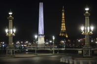 Concorde square is empty during curfew in Paris, Saturday, Oct. 17, 2020. French restaurants, cinemas and theaters are trying to figure out how to survive a new curfew aimed at stemming the flow of record new coronavirus infections. The monthlong curfew came into effect Friday at midnight, and France is deploying 12,000 extra police to enforce it. (AP Photo/Lewis Joly)