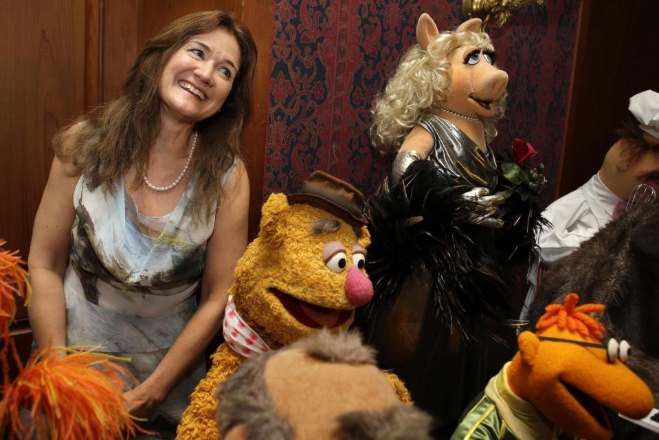 Cheryl Henson, daughter of Jim Henson, left, is surrounded by