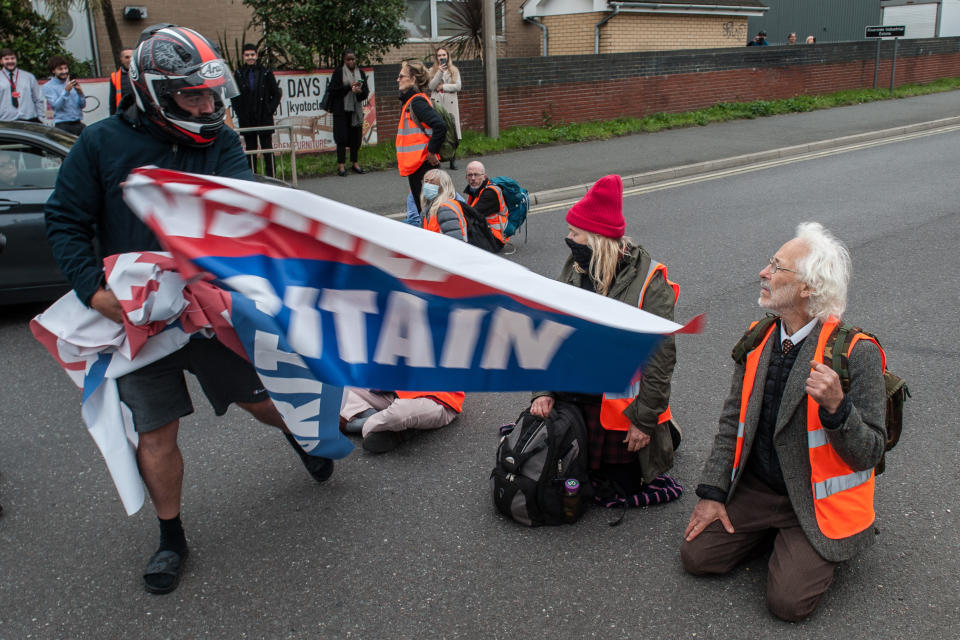 ESSEX, ENGLAND - OCTOBER 13: Angry motorists snatch banners from protestors as activists from Insulate Britain block a junction near the Dartford Crossing on October 13, 2021 in Thurrock, England.(Photo by Guy Smallman/Getty Images)