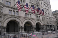 FILE - In this Jan. 15, 2021 file photo, extra security barricades are outside the Trump Hotel in Washington. Trump is returning to a family business ravaged by pandemic shutdowns, with revenue plunging more than 40 percent at his Doral golf property, his Washington hotel and at both his Scottish resorts. Trump’s financial disclosure released as he left office this week was just the latest bad news for his financial empire after banks, brokerages and golf organizations announced they were cutting ties with his company following the storming of the Capitol this month by his political supporters (AP Photo/Susan Walsh, File)