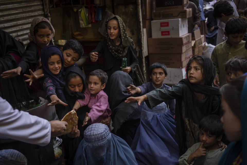 Afghan women and children receive bread donations in Kabul's Old City, Afghanistan, Thursday, Sept. 16, 2021. (AP Photo/Bernat Armangue)