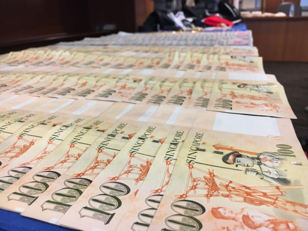 Some $14,000 in cash and luxury items purchased with stolen money were recovered by the police. (PHOTO: Yahoo News Singapore/Nicholas Yong)