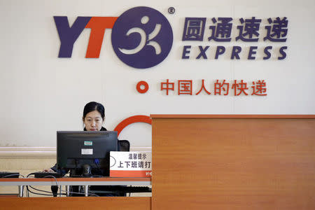 An employee works behind a desk at a YTO Express logistics centre in Beijing, China, March 25, 2016. REUTERS/Jason Lee/File photo