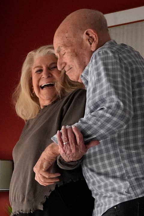 World War II veteran Harold Terens, 100, right, and Jeanne Swerlin, 96, show off their moves as they dance to Bruno Mars’ “Uptown Funk,” Thursday, Feb. 29, 2024, in Boca Raton, Fla. Terens will be honored by France as part of the country’s 80th anniversary celebration of D-Day. In addition, the couple will be married on June 8 at a chapel near the beaches where U.S. forces landed. (AP Photo/Wilfredo Lee)