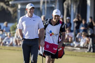 Rory McIlroy, left, of Northern Ireland, walks up the 18th fairway with his caddie during the final round of the CJ Cup golf tournament Sunday, Oct. 23, 2022, in Ridgeland, S.C. (AP Photo/Stephen B. Morton)