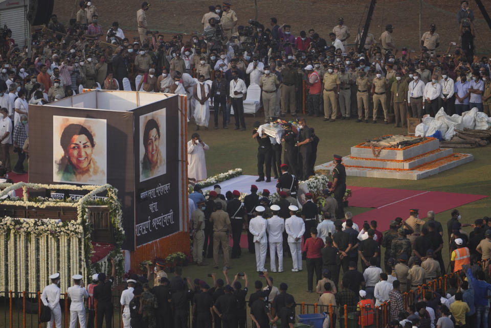 Defense forces carry the body of Lata Mangeshkar during funeral, in Mumbai, India, Sunday, Feb.6, 2022. The legendary Indian singer with a prolific, groundbreaking catalog and a voice recognized by a billion people in South Asia, died Sunday morning of multiple organ failure. She was 92. (AP Photo/Rafiq Maqbool)