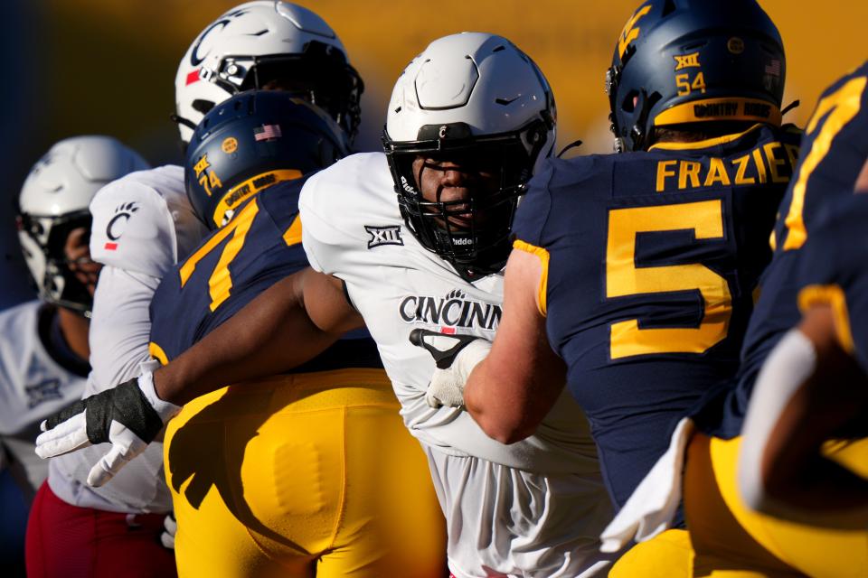 Cincinnati Bearcats defensive lineman Dontay Corleone (2) rushes the quarterback at West Virginia Nov. 18. Corleone will return to UC for his redshirt junior season.