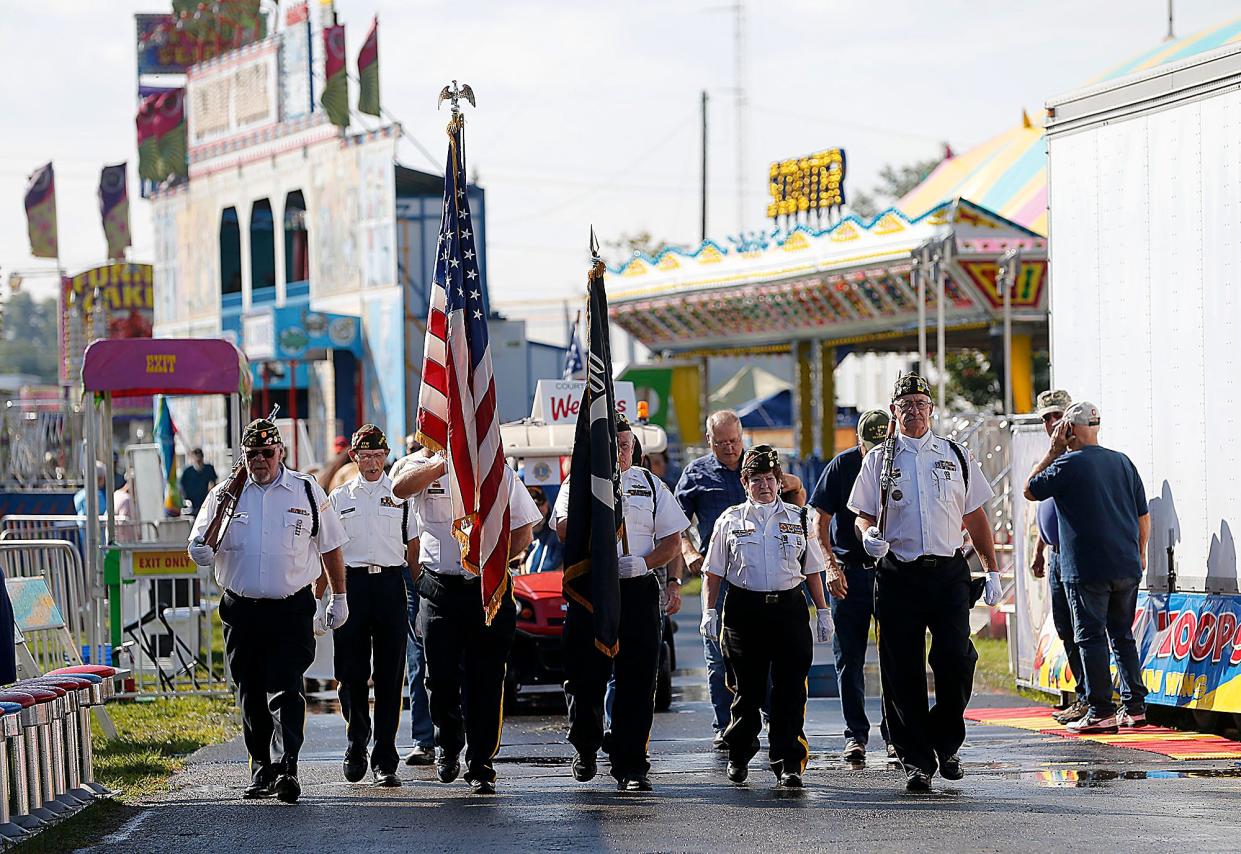 The Ashland Honor Guard leads area veterans in the Walk of Honor to the Spidel Entertainment Pavilion for the Veteran's Day service at the Ashland County Fair on Monday, Sept. 19, 2022.