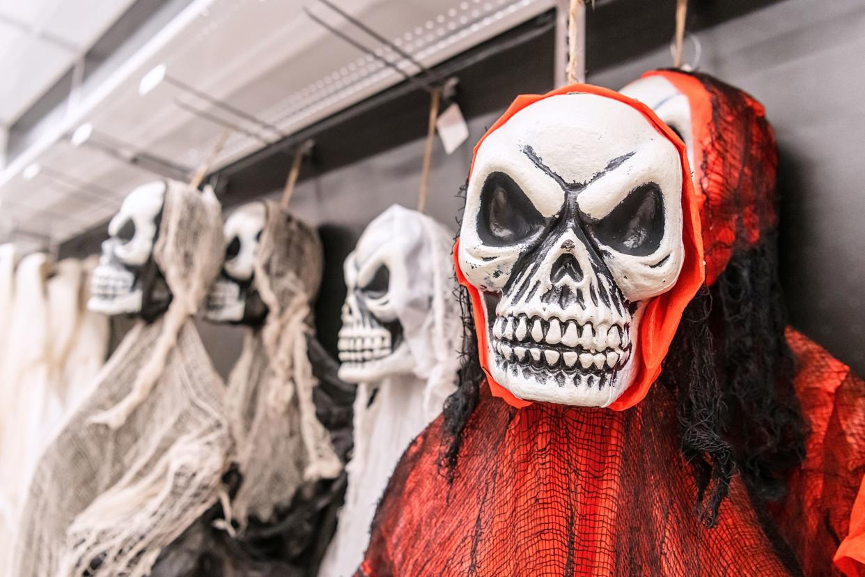 Halloween masks for sale in a discount store shelf