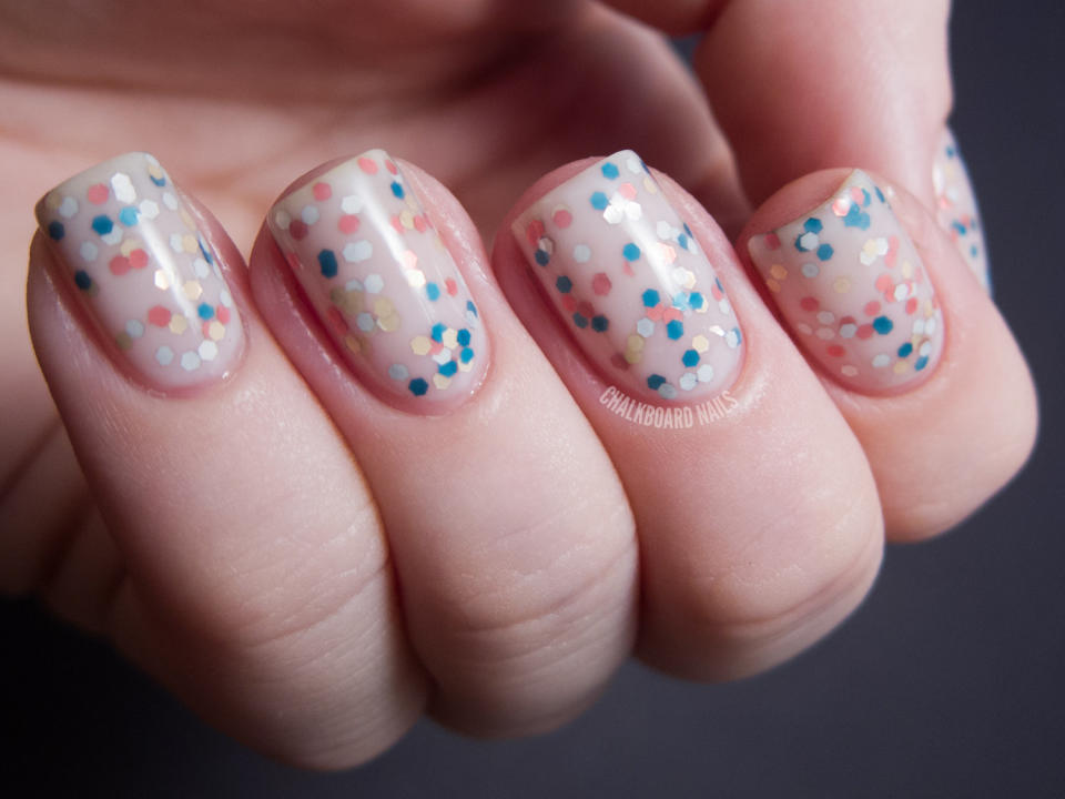 "This is a 'jelly sandwich' manicure that I created using OPI Don't Touch My Tutu and The Living Daylights. A jelly sandwich design can be created by putting a glitter polish in between layers of a sheer, semi-opaque polish. It makes the glitter look buried, creating a neat and different effect." - Sarah of <a href="http://www.chalkboardnails.com/2012/11/some-opi-skyfall-manicures.html">Chalkboard Nails</a>