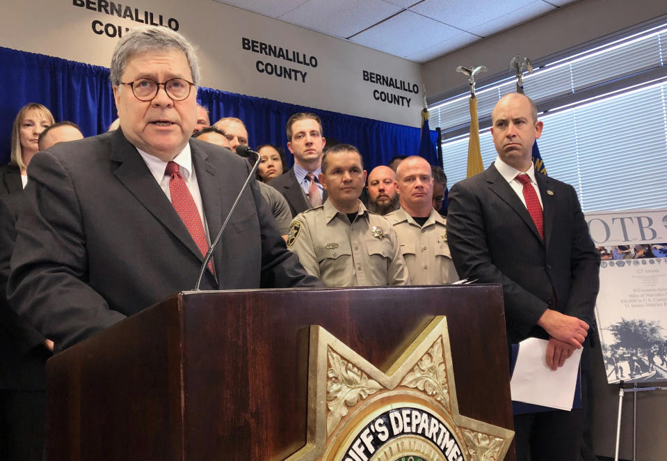 U.S. Attorney General William Barr, left, with other federal and officials, announces that nearly 330 fugitives suspected of violent crimes have been arrested as part of a crime-fighting initiative in New Mexico, at a news conference at the office of the Bernalillo County Sheriff in Albuquerque Tuesday, Nov. 12, 2019. Barr was in Albuquerque to highlight the results of Operation Triple Beam, a program that has been conducted in numerous U.S. cities and has led to hundreds of arrests. (AP Photo/Mary Hudetz)