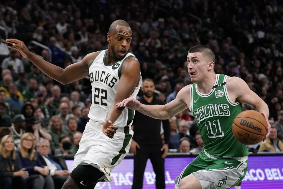 Boston Celtics' Payton Pritchard tries to get past Milwaukee Bucks' Khris Middleton during the second half of an NBA basketball game Thursday, April 7, 2022, in Milwaukee. The Bucks won 127-121. (AP Photo/Morry Gash)