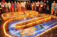 Earth Hour 2010, Citizens of Jakarta in traditional costumes supporting Earth Hour, Jakarta, Java, Indonesia. <br> <a href="http://www.worldwildlife.org/sites/earthhour/index.html" rel="nofollow noopener" target="_blank" data-ylk="slk:For more information about Earth Hour 2012, visit WWF.;elm:context_link;itc:0;sec:content-canvas" class="link ">For more information about Earth Hour 2012, visit WWF.</a>