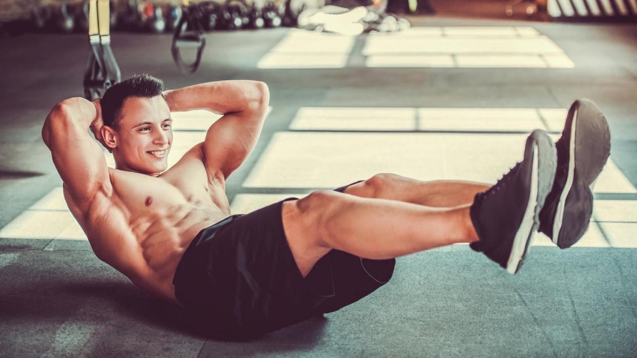  Man performing crunches during ab workout. 