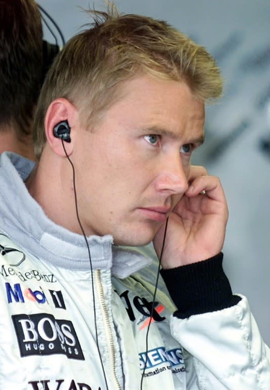 World Formula One champion in 1998 and 1999, McLaren-Mercedes driver Mika Hakkinen of Finland, watches a television monitor during the qualifying practice session of the Japanese Formula One Grand Prix in Suzuka in 2000