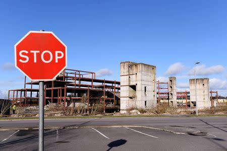 A road sign stands in front of a building site for a hotel that was never completed in Edenderry, Ireland February 18, 2016. REUTERS/Clodagh Kilcoyne