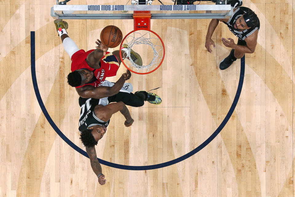 New Orleans Pelicans forward Zion Williamson goes to the basket against San Antonio Spurs forward DeMar DeRozan (10) in the second half of an NBA basketball game in New Orleans, Wednesday, Jan. 22, 2020. The Spurs won 121-117. (AP Photo/Gerald Herbert)