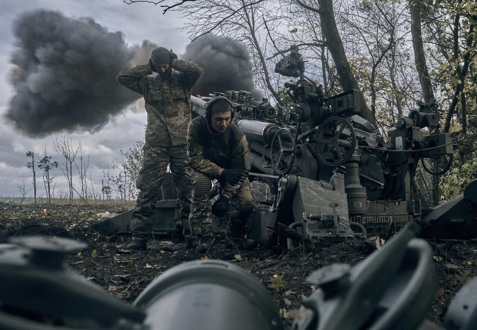 Ukrainian soldiers fire at Russian positions from a U.S.-supplied M777 howitzer in Ukraine's eastern Donetsk region Sunday, Oct. 23, 2022. (AP Photo/LIBKOS)