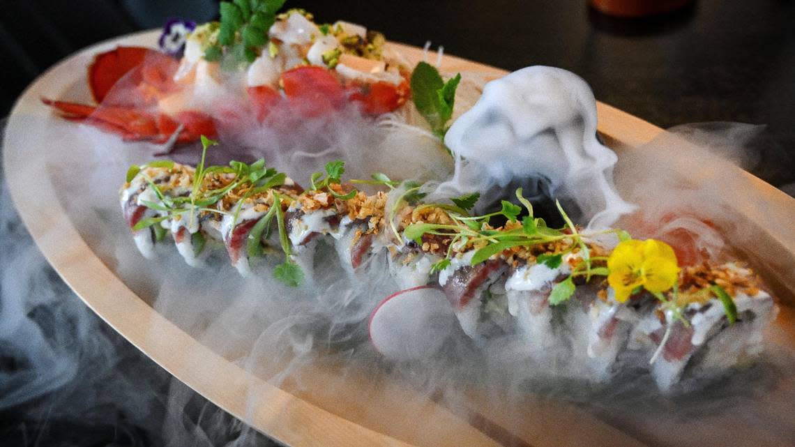 The king of the seas specialty maki is a sushi roll featuring Wagyu beef, baked lobster, asparagus, avocado and yuzu aioli paired with a lobster fruit salad and arriving at your table with dry ice fog flowing out of a serving boat at O-iza Japanese Cuisine in the River Park shopping center.