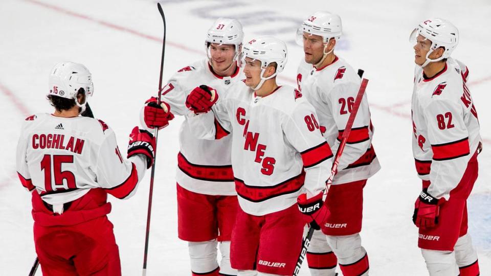 Carolina Hurricanes’ Dylan Coghlan (15) is greeted by teammates Andrei Svechnikov (37) Martin Necas (88) and Jasper Kotkaniemi (82) after an assist on a goal by Paul Stastny (25) during the second period of an NHL preseason game against Tampa Bay on Tuesday, September 27, 2022 at PNC Arena in Raleigh, N.C.