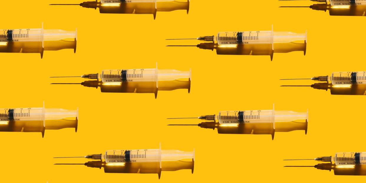 pattern of syringes with a vaccine on yellow background concept of medical treatment or vaccination