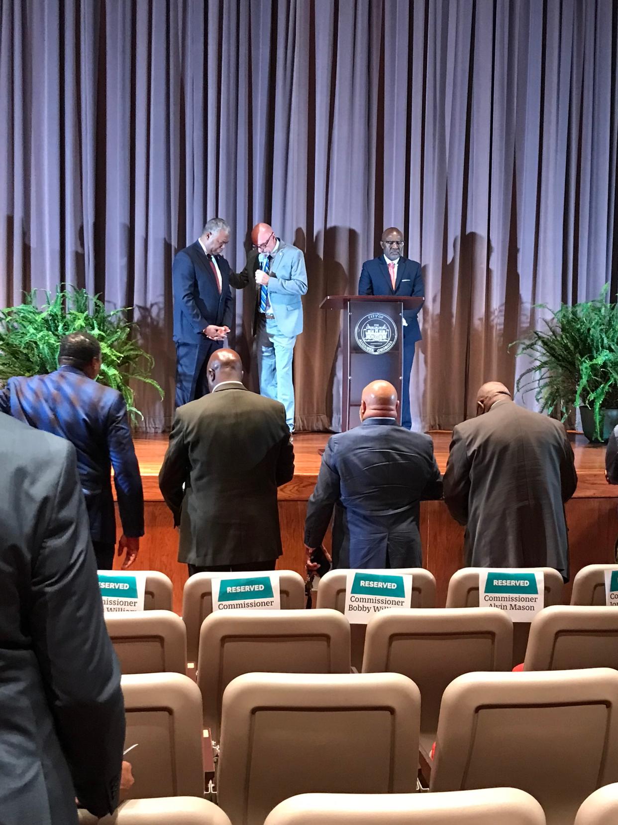 Augusta Mayor Hardie Davis Jr., left, prays with Bridge Ministry of the CSRA Pastor Roger Gardner, center, and Destination Augusta President Bennish Brown, who served as master of ceremonies at Davis' last state-of-the-city address at Augusta Technical College on Thursday.